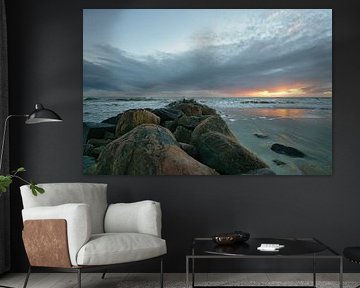Large stones on the sandy beach at sunset in Denmark by Martin Köbsch