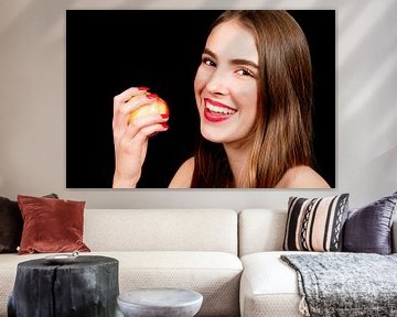 Young woman eats an apple by Anita Hermans
