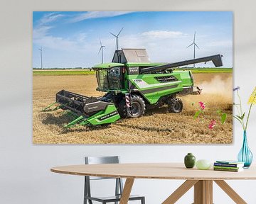A farmer is harvesting grain in Eemshaven by Dennis Venema