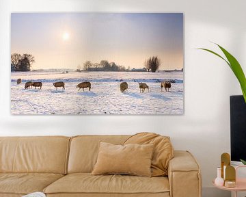 Moutons dans un paysage d'hiver