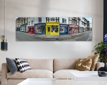 Panorama of colourful shops in street of Alchester, England. by Albert Brunsting