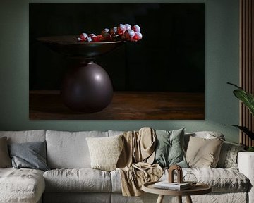 Red grapes in a brown etagere against a black background with co