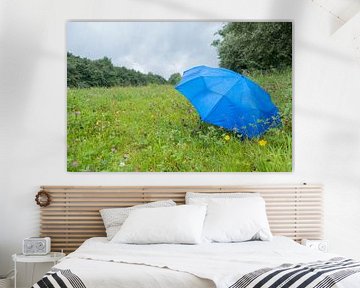 Schuilen voor de regen onder een blauwe paraplu