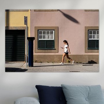 Girl walking in the evening sun in Porto