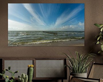 Marker mudflats breakwaters and billowing clouds by R Smallenbroek