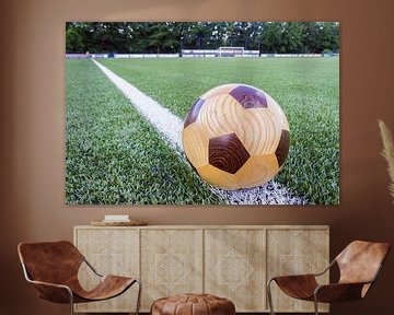 Wooden soccerball on sideline by Ben Schonewille