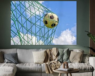 Voetbal in net van goal tegen blauwe lucht van Ben Schonewille