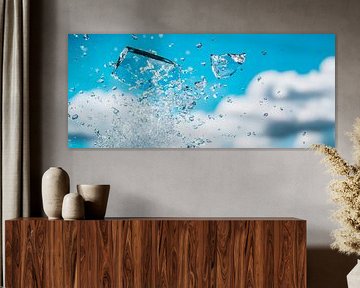 Splashing water under a blue sky by Poster Art Shop