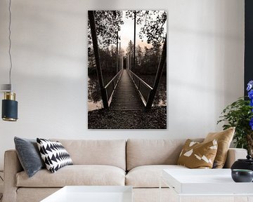 A mysteriously long bridge above the water in black and white