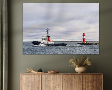Tugboat and pier tower on the Baltic coast in Warnemünde by Rico Ködder