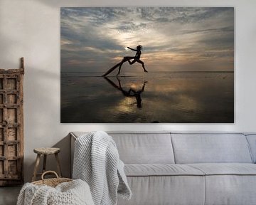 Artistic nude in the Wadden Sea jumping high by Arjan Groot