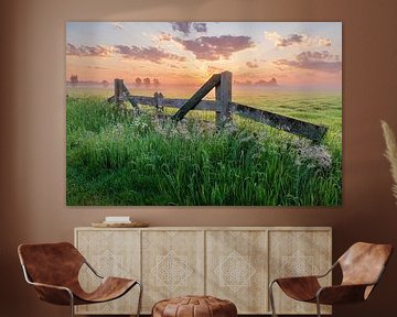 Farm gate in meadow at colourful sunrise by Sjaak den Breeje