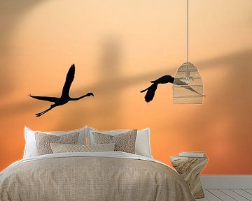 Flight at Dusk Silhouette of Flamingo's against a Fiery Orange Landscape by Femke Ketelaar