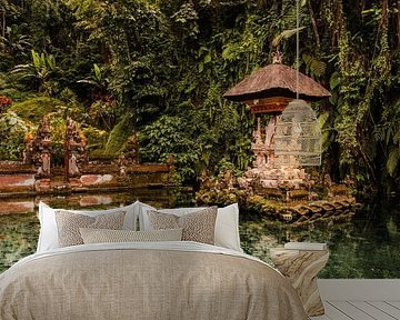 Balinese water temple, part in the clear blue water of the pond