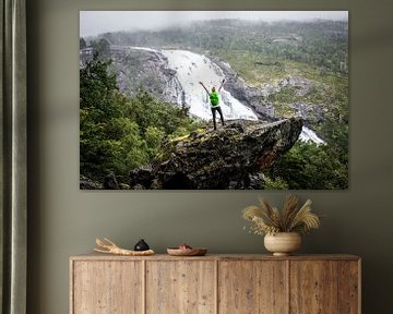 Adventure at Nyastølfossen: Hiker on a Rock in front of the Majestic Waterfall