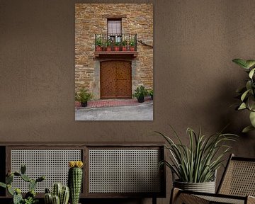 Door with decoration of wrought-iron rivets in the door and a balcony by Ton Van Zeijl