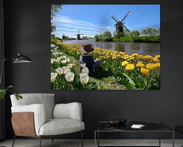 A boy on a field in bloom in spring by Claude Laprise
