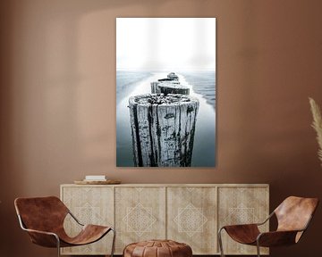 Rustic high key photo of breakwater on beach
