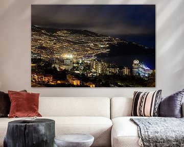 Funchal in Madeira in the early evening with illuminated cruise ship and lights in the city by Eric van Nieuwland