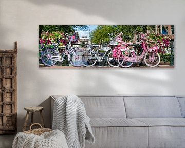Amsterdam in de zomer: fietsen en bloemen op de brug over het kanaal in de Nederlandse metropool