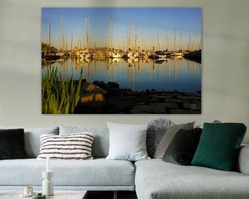 Reflections of boats in a harbour.