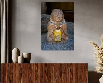 Stone Buddha figurine with a Japanese amulet by Frans Rombout