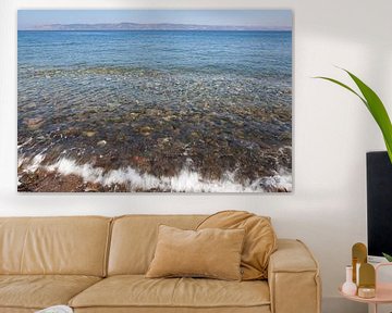 Seawater undulates over pebbles in the Aegean Sea by Frans Rombout