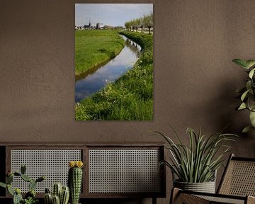 Frühlingslandschaft mit einer Windmühle und einem Kirchturm von Frans Rombout
