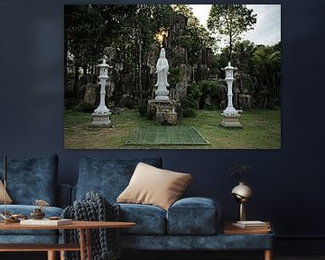 Bodhisattva statue in a sacred garden by Frank Photos