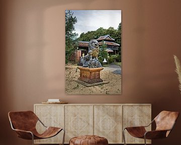 Carved lion watching over a sacred pagoda by Frank Photos