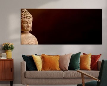 Buddha bust in front of a dark background by Alexander Baumann