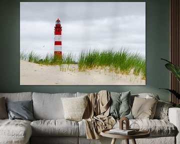 Amrum lighthouse in front of dunes and clouds by Alexander Baumann