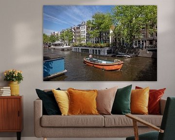 Canal in Amsterdam with orange sloop.