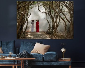 Two Vietnamese women walk among Mangrove trees by Anges van der Logt