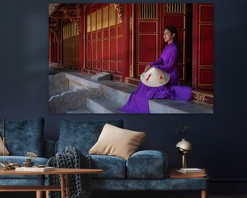 Vietnamese woman sits on the steps to the temple by Anges van der Logt