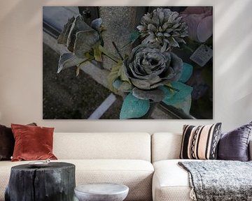 Wilted silk flowers in a cemetery by SACKGASSE