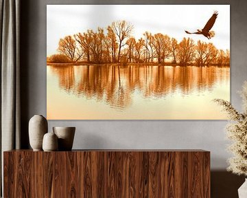 Row of trees along the water in sepia by Jose Lok