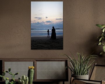 A tender moment by the sea at sunset by Frank Photos