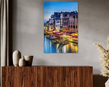 Gondolas moored along Grand Canal buildings at dusk by insideportugal