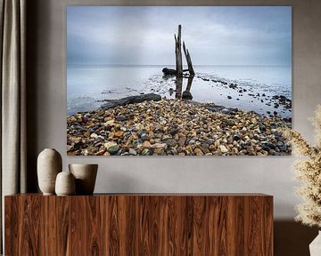 Pebble beach with wooden posts Den Osse Netherlands by Sonny Vermeer