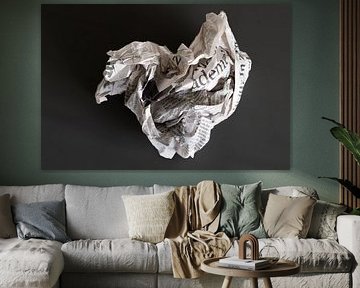 What remains of yesterday: a newspaper clump against a dark background