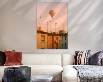 Hot air balloon over pastel houses - soft evening sky with warm colours