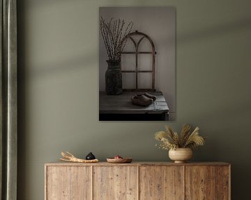 Rural still life with stable window, willow catkins and wooden clogs