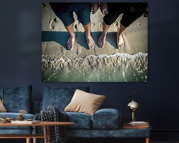Two Pairs of Feet on Beach Sand at Water's Edge by Markus Gann