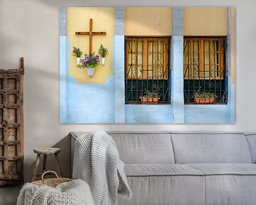 Colourful house facade with cross and flowers by Alexander Baumann