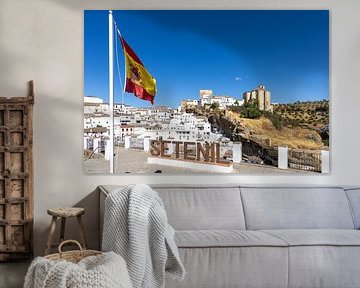 Panorama or skyline of a historic old town with many white houses. The Spanish flag in Setenil de las Bodegas, Cádiz, Andalusia, Spain. by Fotos by Jan Wehnert