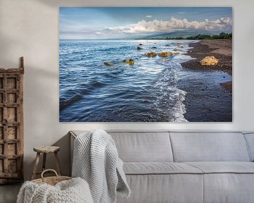 a dark sand beach in northern Bali Indonesia