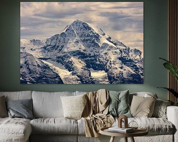 The sun breaks through the clouds, above the Mönch by Reinier Holster