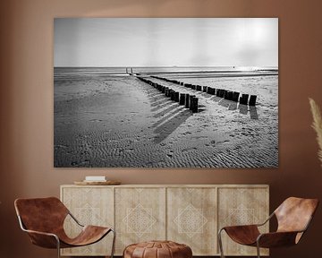 Postes de plage en noir et blanc Symétrie Rythme et réflexion sur la côte sur Femke Ketelaar