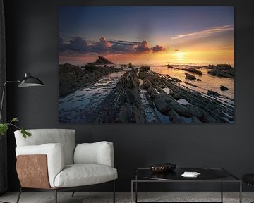 Rocks in the sea at sunset in Livorno, Tuscany by Stefano Orazzini